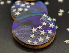 three cookies decorated with stars on top of a table