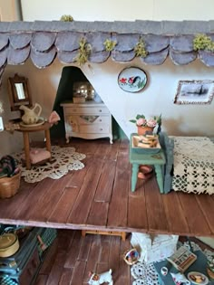 a doll house with furniture and accessories on the floor