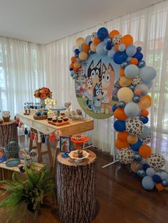 a party with balloons and decorations on the table