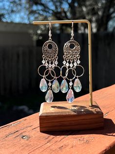 Made with a circular shape base with silver circles, clear crystals on silver wire & iridescent light blue tear drops on silver wire. Earring hooks are hypoallergenic.  These are teardrop style earrings inspired by Greta Van Fleet's Tears of Rain!  Make sure to clean earring hooks before use! Thank you for checking out my jewelry, I hope your day is filled with overflowing light & love :-) Silver Crystal Dangle Teardrop Earrings, Sparkling Silver Dangle Teardrop Earrings, Silver Sparkling Dangle Teardrop Earrings, Teardrop Crystal Earrings With Ear Wire, Adjustable Teardrop Crystal Earrings, Silver Drop Crystal Earrings With Ear Wire, Silver Teardrop Crystal Earrings With Ear Wire, Adjustable Metal Teardrop Crystal Earrings, Silver-plated Teardrop Jewelry With Ear Wire