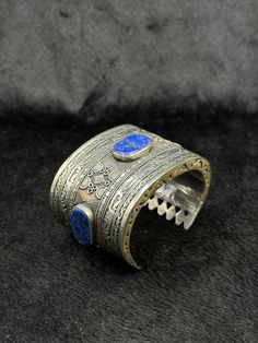 Beautiful Rare Vintage Handicraft Afghani Silver Bangle With Lapis Lazuli Stone From Afghanistan. Unique Bangle For Collection. Shipping Payment Feedback & Return Policy 1 : We ship Monday to Friday Via Airmail Register Insured  With Tracking # takes 2 to 4 Weeks to Destination. 2 : Contact us if you did not receive your item after 4 weeks. 3 : We Accept Payment From Most of the Mainstream Payment Methods. 4 : In Any Inconvenience Case we do Accept Return and full Refund. 5 : We Ship worldwide v Artisan Handmade Blue Bangle, Blue Bracelet With Intricate Design As A Gift, Handmade Artisan Blue Cuff Bracelet, Handmade Ceremonial Blue Jewelry, Artisan Blue Cuff Bracelet For Festivals, Artisan Handmade Blue Cuff Bracelet, Unique Blue Ceremonial Jewelry, Unique Blue Jewelry For Ceremonial Occasion, Adjustable Artisan Blue Bangle