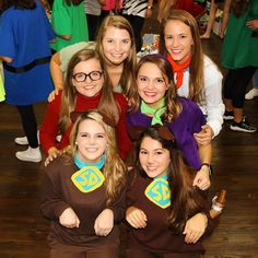 a group of young women standing next to each other in front of a wooden floor