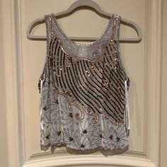 This Is An Absolutely Beautiful Beaded Sleeveless Top. Made Of Semi-Sheer Cream Colored 100% Silk Adorned With Bronze Embroidery, Tiny Silver Beads And Shiny Copper And Matte Gold Sequins. Back Zipper (Full Length) This Top Is A Real Stunner!! Brand New With Tags. Purchased At A Boutique, Never Worn. Size Small Glamorous Embellished Summer Tank Top, White Embellished Tank Top, White Embellished Sleeveless Tank Top, Spring Beaded Fitted Tank Top, Glamorous Embellished Sleeveless Tank Top, Beaded Fitted Tank Top For Night Out, Fitted Beaded Sleeveless Tank Top, Fitted Beaded Tank Top For Night Out, Sleeveless Party Tank Top With Beaded Straps