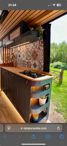 a kitchen with an oven, stove and sink in the middle of a yard area