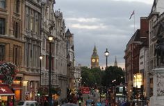 a busy city street filled with traffic and tall buildings