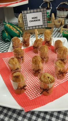 mini muffins are arranged in small cups on a table with gingham cloth