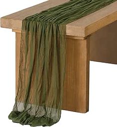 a wooden bench with a green scarf hanging from it's back end, on a white background