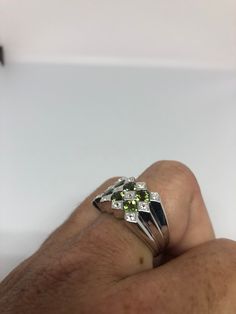 Rich and very bright Peridot green ring white white sapphire Sterling silver with rhodium finish Size 8, can be sized by my jeweler. His service charge is $10-$20 All rings are shipped in a nice gift box. Check out our over a THOUSAND great reviews Engraving is $4 per letter and is not always perfect depending on the piece. It can take a few days if the jeweler is busy. This is payable to Paypal Judithsltd@gmail.com Green Diamond Cut Diamond Ring, Green Diamond Ring With Diamond Accents, Fine Jewelry Green Diamond Cut Diamond Ring, Green Multi-stone Diamond Ring, Silver Diamond Ring With May Birthstone Accents, Classic Green Multi-stone Sapphire Ring, Green Diamond Ring With Diamond Cut As Gift, Green Rings With Diamond Accents, Green Diamond Rings With Diamond Accents