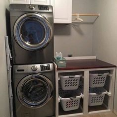 a washer and dryer in a laundry room with baskets under the front door