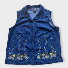 Adorable embroidered flowers jean sleeveless shirt. 100% cotton so it's quite soft.  Size vintage 14P. In good vintage condition. The buttons are a shiny blue. Approximate Measurements (measured flat and buttoned): Pit to pit - 21" Length - 24" **Mannequin measurements are approximately Shoulder to shoulder width 15.2"; Bust 41.8"; Waist 35.6"; Hip 44.5"** Sleevless Top, Flowers Daisy, Sleeveless Shirt, Plus Size Blouses, Embroidered Shirt, 90s Vintage, Embroidered Flowers, Denim Shirt, Womens Clothing Tops