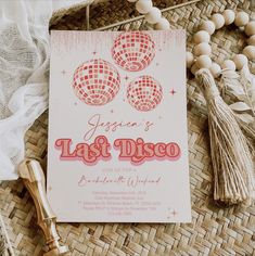 an image of a party card with disco balls and tassels on the table