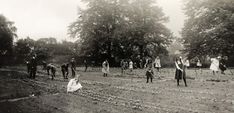 an old black and white photo of people in a field