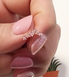 a woman's hand with some pink and white nails