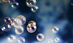 soap bubbles floating in the air on a blue background