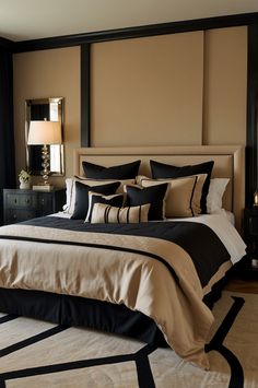 a large bed with black and tan comforter in a bedroom next to a window