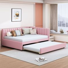 a living room with a pink couch and ottoman