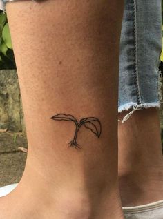 a woman's foot with a small bird tattoo on the side of her leg