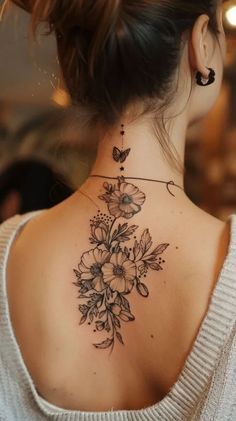 a woman with a flower tattoo on her neck