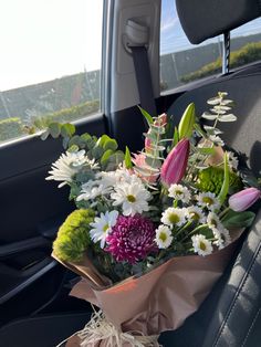 a bouquet of flowers in the back seat of a car