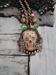 "All my creations, even the smallest are made in a single copy (unique piece)   Gothic Skull Pendant\" UNAKITE beads and genuine cut crystals. The cabochon is made of \"crystal\" resin with metal inclusions and small white glass crystals. Gothic Pendant Necklace sold with its gold and black braided metal chain. - size height 5 cm /1.77\"x Wide 4.8 cm/  1.57\"  Nice gift idea. Mid-length neck circumference = 28 cm/11.02\"" Day Of The Dead Beaded Jewelry Gift, Handmade Gothic Skull Necklace, Unique Handmade Skull Necklace, Halloween Spiritual Skull Jewelry, Bohemian Skull Necklace For Gifts, Bohemian Skull Necklace For Gift, Bohemian Skull Shaped Necklace For Gift, Festival Skull-shaped Beaded Jewelry, Gold Skull Bohemian Jewelry