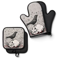 two oven mitts with skulls and birds on them, one has a bird sitting on the skull