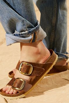 **Fit:** Narrow: A-B Width Classic two-strap style Birkenstock featuring large statement buckles and a distressed look. Genuine leather straps are featured with comfortable, lightweight sole. * Anatomically shaped cork-latex footbed A Birkenstock narrow width fit is comparable to a Medium (B Width). | Birkenstock Arizona Big Buckle Sandals at Free People in Brown, Size: EU 36 Birkenstock Big Buckle Outfit, Birkenstock Street Style, Big Buckle Birkenstock, Birkenstock Big Buckle, Arizona Big Buckle, Birkenstock Styles, Birkenstock Outfit, Birkenstock Style, Buckle Outfits