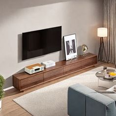 a living room with a couch, coffee table and television on top of the entertainment center