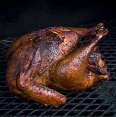 a whole chicken sitting on top of a grill