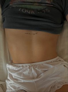 the back of a woman's stomach with writing on it