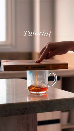 a person is pouring tea into a cup