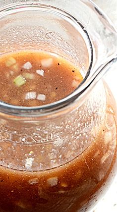 a glass pitcher filled with soup sitting on top of a table