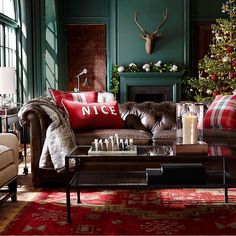 a living room filled with furniture and a christmas tree in the backgroung