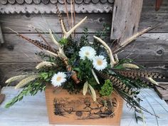 a wooden box filled with flowers and plants