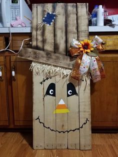 a scarecrow door hanger made out of wood planks