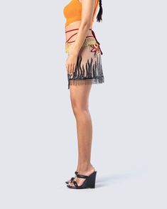 If you obey all the rules, you miss all the fun 😜 Show off your free-spirited side in this mesh wrap-around tie mini skirt designed with a tassel hem and embroidered patch detailing 🔥 Leave little to the imagination -- skirt is sheer & undergarments are not included Summer Party Skirt With Beaded Fringe, Summer Party Bottoms With Beaded Fringe, Summer Party Shorts With Fringe, Summer Fringe Mini Bottoms, Fitted Fringe Mini Skirt For Festival, Festival Fitted Fringe Mini Skirt, Fitted Skirt With Beaded Fringe For Summer, Fitted Beaded Fringe Skirt For Summer, Summer Party Bottoms With Tassels