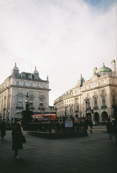 people are walking around in the city square