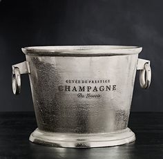 a silver bucket sitting on top of a wooden table