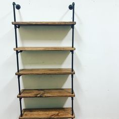 an industrial style shelving unit with four shelves and three pipe brackets on each shelf