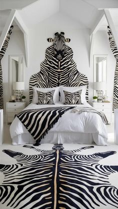 a zebra print rug is on the floor next to a bed