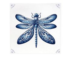 a blue dragonfly sitting on top of a white tile