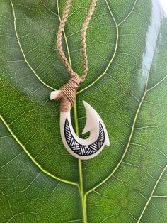 "Maori Hei Matau New Zealand Fish Hook Buffalo Bone Pendant with Adjustable Cotton Cord Necklace Pendant: Approx. 2\" long, 1\" wide Cord Necklace: Approx. 28\" long (Adjustable)" Maori Necklace, Maori Hook, Maori Greenstone Necklaces, Handmade White Fish-shaped Jewelry, Maori Fish Hook Necklace, Angler Fish Necklace, Cotton Cord Necklace, Bone Necklace, Bone Pendant