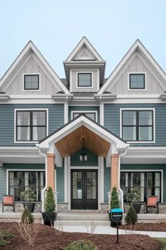 a blue house with white trim and windows