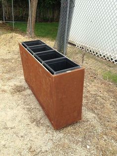 a brown box sitting on top of a dirt field