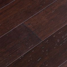 an orange cat laying on top of a wooden floor