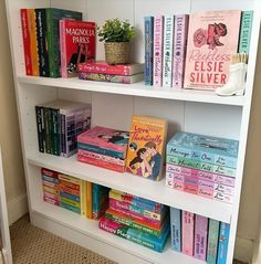 a white book shelf filled with lots of books