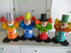 four colorful clowns are sitting on the counter