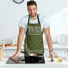 a man in an apron is cooking food on the stove with his hands out to the side