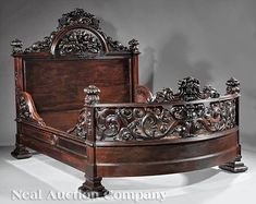 an ornate wooden bed frame with intricate carvings