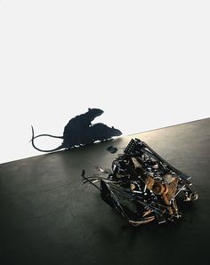 a pile of junk sitting on top of a floor next to a metal mouse pad