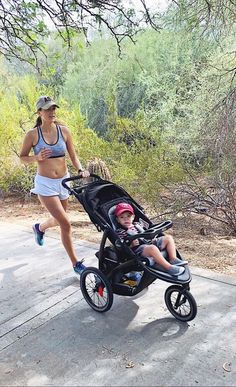 a woman jogging with her baby in a stroller